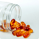 Open bottle of amber supplement softgels representing an in-house dispensary