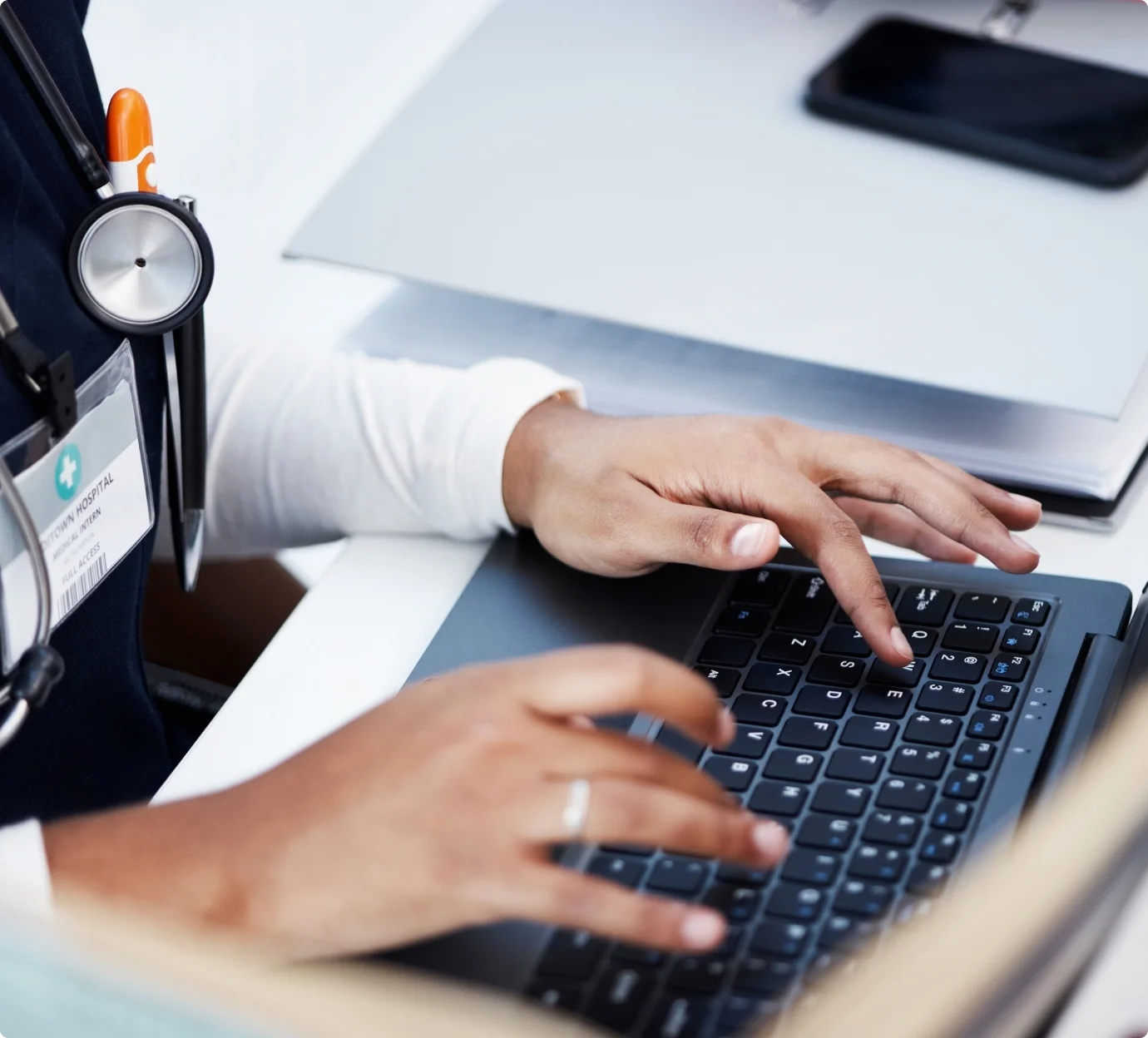 Healthcare professional reviewing patient data on laptop
