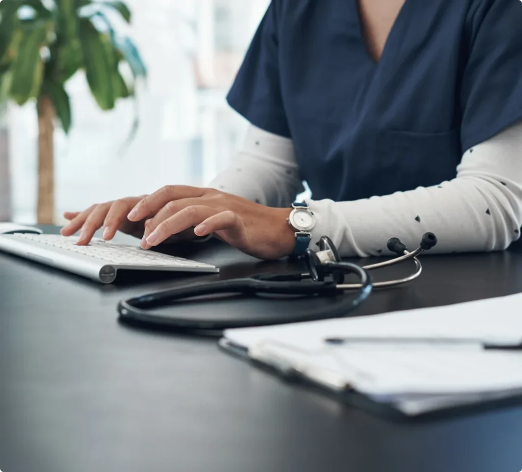 Clinician reviewing patient data on a laptop